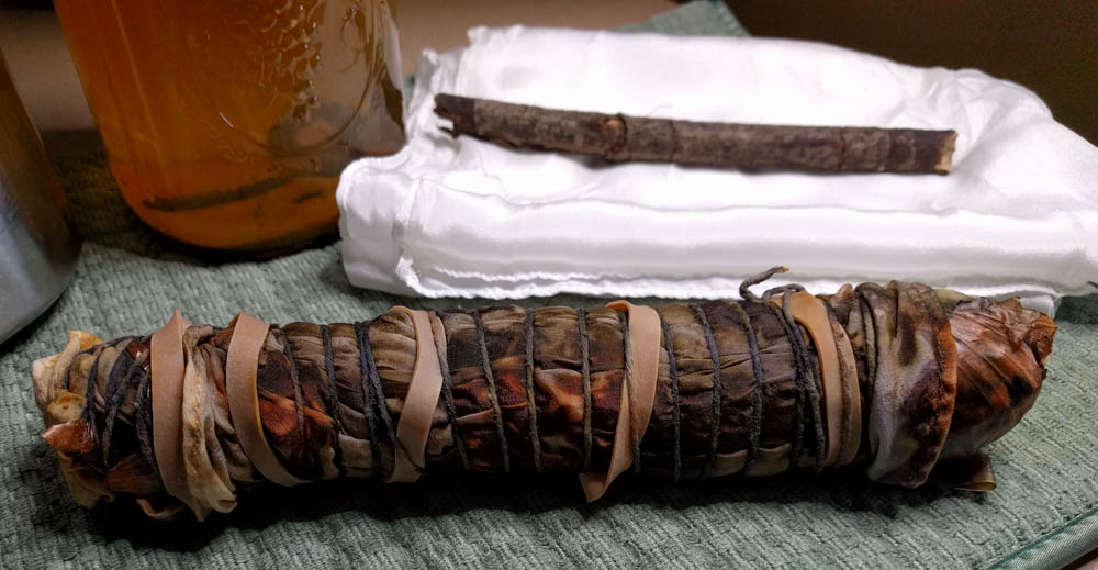 Bundle of silk, onion skins, and iron-soaked muslin